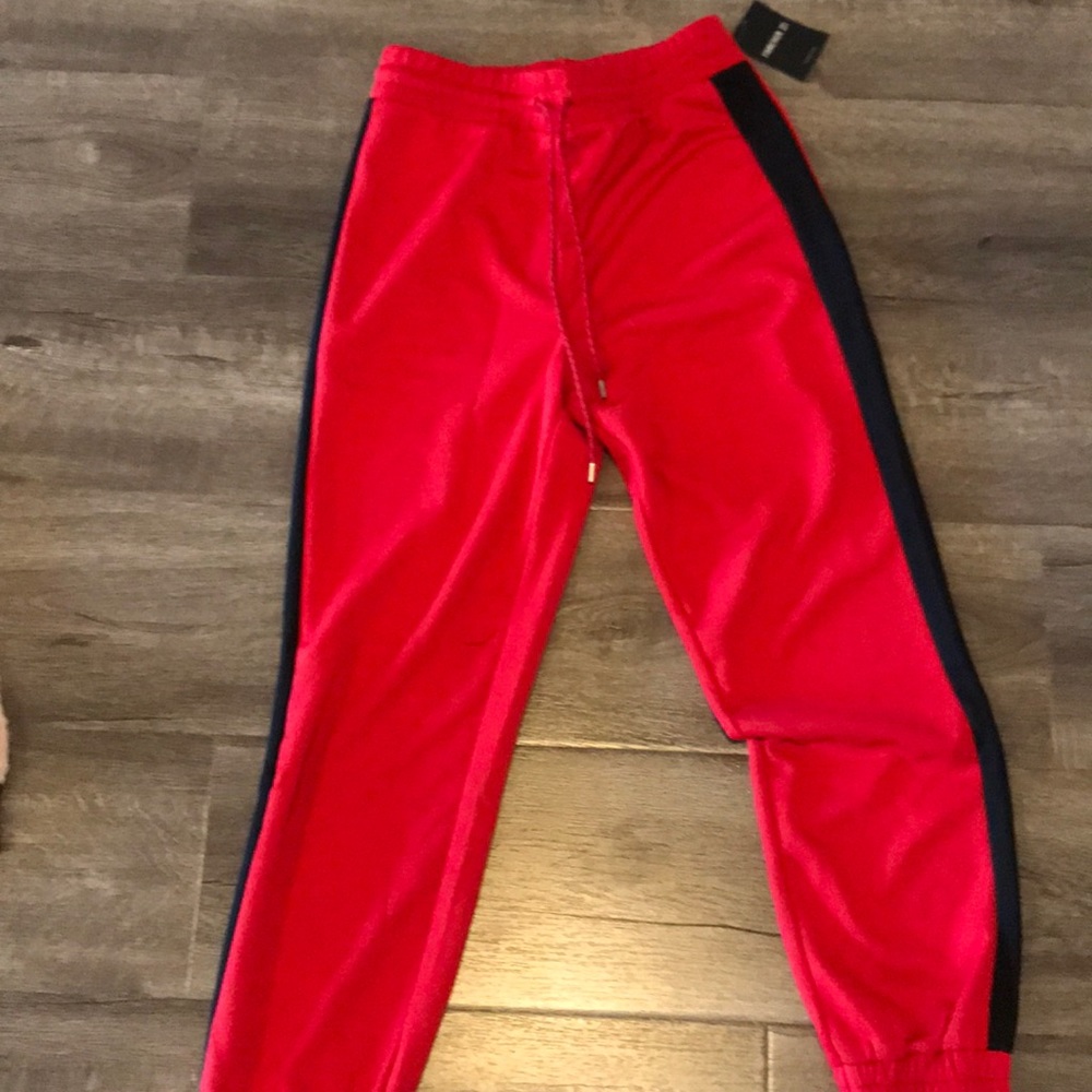 Red joggers w/ black stripe.